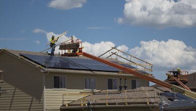 worker repairing the roof of a house
