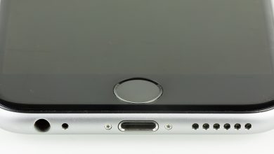 A person unlocking a smartphone with a fingerprint